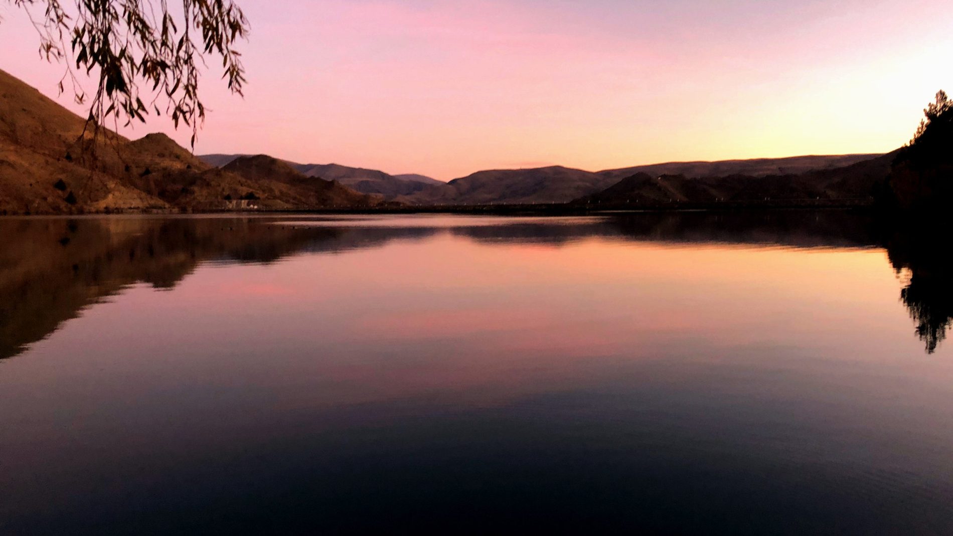 Sunset over Lake Benmore, the water flat and pink